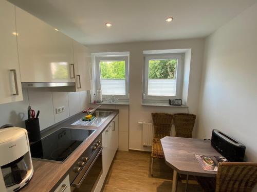 a kitchen with a table and a counter top at Steinweg 7 Ferienwohnung in Kassel