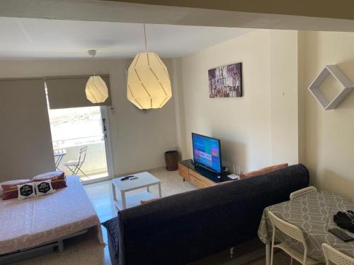 a living room with a couch and a television at Comfort Apartment in Larnaka