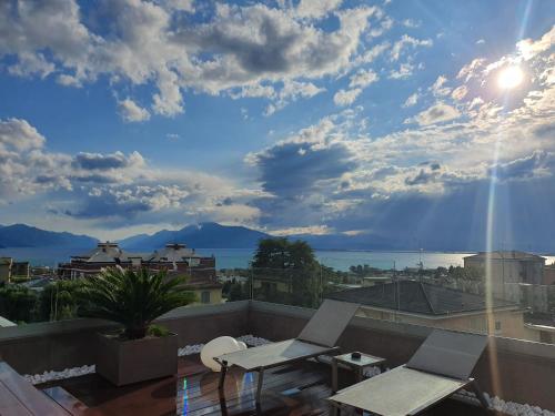 a balcony with chairs and a view of the sky at Hotel Desenzano in Desenzano del Garda