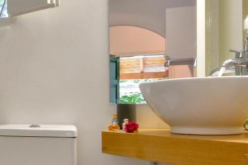a bathroom with a sink and a toilet at Minimalist Cozy House in Corfu