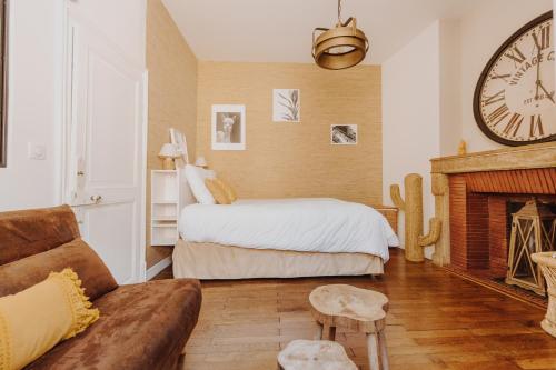 a bedroom with a bed and a large clock on the wall at L'échappée in Bourges