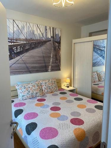 a bedroom with a bed with a polka dot blanket at One-bedroom Apartment near Atomium in Brussels
