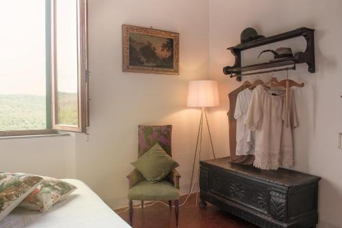 a bedroom with a bed and a dresser and a lamp at Tenuta Santa Trice in Riotorto