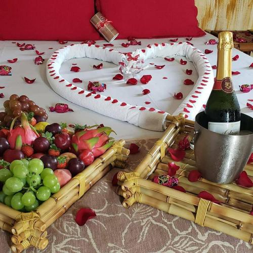 a table with a tray of fruit and a bottle of wine at Hotel Natural - SPA & Lazer in Brotas