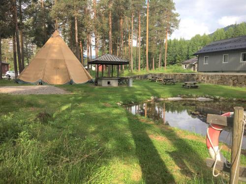 a yurt with a picnic table and a pond at Torpomoen in Torpo