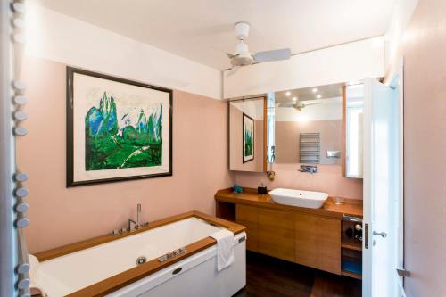 a bathroom with a tub and a sink at Villa Glicine in Gardone Riviera