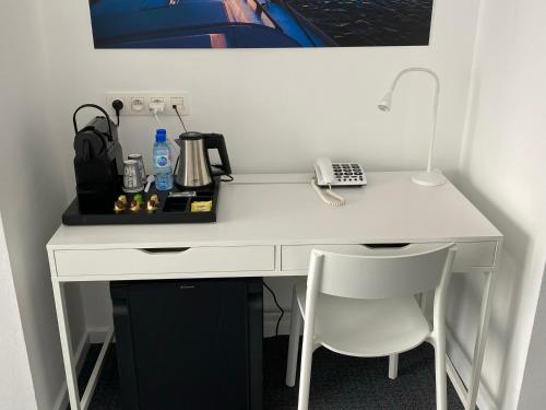 
a desk with a laptop and a printer on it at Avenue Beach Hotel in Ostend
