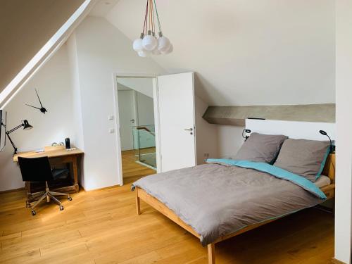 a bedroom with a bed and a desk in it at Exklusives Penthouse im ehemaligen Bunker in Hannover