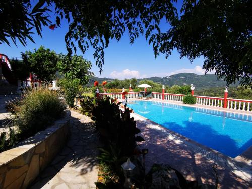 a swimming pool in a villa with mountains in the background at Villa PANGALIS Romantica in Kato Pavliana