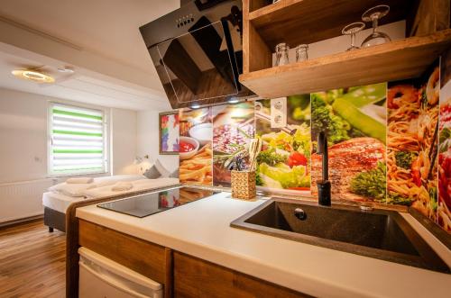 a kitchen with a sink and some pictures on the wall at MoselUnion - "schlafen & genießen" in Cochem