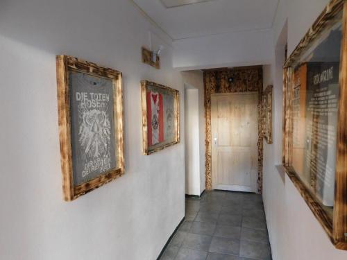 a hallway with paintings on the walls of a building at Haus Feierabend in Plodda