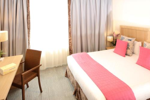 a hotel room with a large bed and a desk at Trinite Hotel in La Trinité-sur-Mer