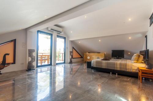 a bedroom with a bed and a television in it at Malee Beach A1 in Ko Lanta