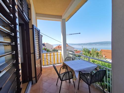 a balcony with a table and chairs and a view at Apartments Balticadriatic in Dramalj