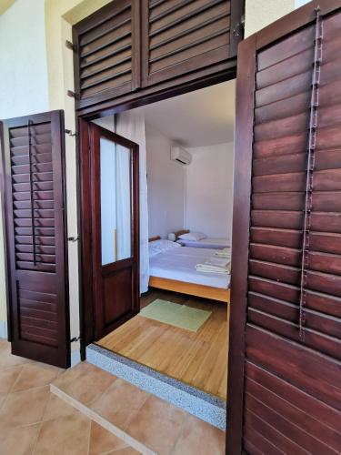a room with a bed and a large wooden door at Apartments Balticadriatic in Dramalj
