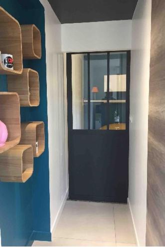 a room with a door with a window and a table at Dans la Pouncho d’Agast in Millau