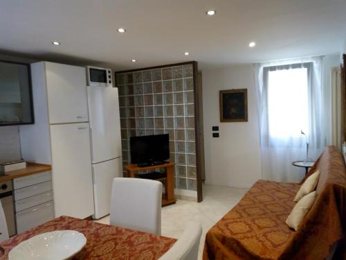 una cucina e un soggiorno con frigorifero bianco di Apartment with a Secret and Romantic Park a Venezia