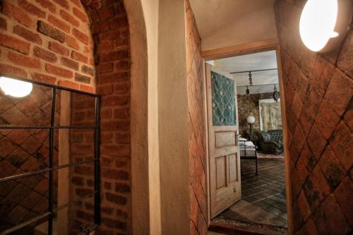 a hallway with a brick wall and a door at Housův Mlýn in Tábor