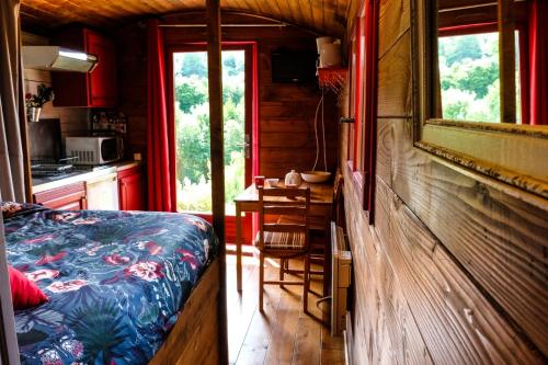 une chambre avec un lit et une cuisine avec une table dans l'établissement Domaine Les Chillards, à Fauguernon