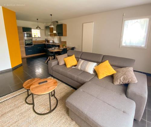 a living room with a couch and a table at Maison à 800m de la plage in Saint-Lunaire