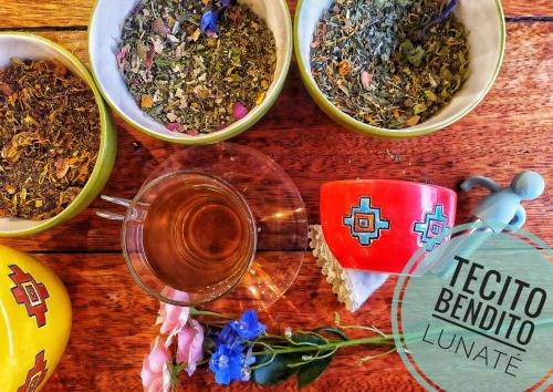 a table with four bowls of herbs and a cup of tea at Chakana Hotel Boutique Centro in Quito