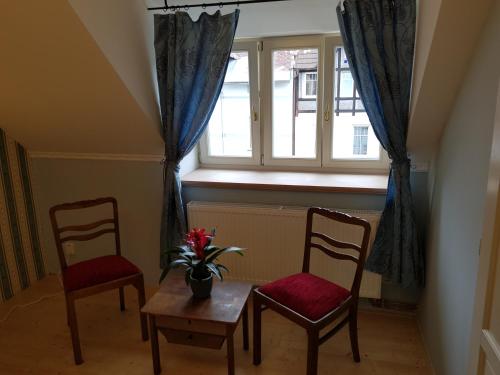 a room with two chairs and a table and a window at Vila Janáčkova - 1st republic villa in Trutnov