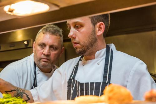 two chefs standing in a kitchen preparing food at Number Four at Stow in Stow on the Wold
