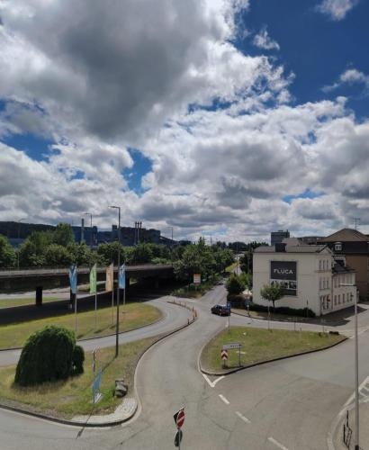 a winding road in a city under a cloudy sky at De Lux Gästehaus Völklingen in Völklingen