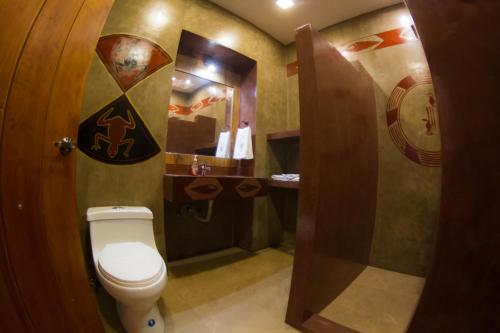 a bathroom with a toilet and a sink at Chakana Hotel Boutique Centro in Quito