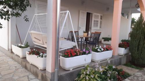 a row of flower pots on the side of a house at Apartment Viki in Lozovac