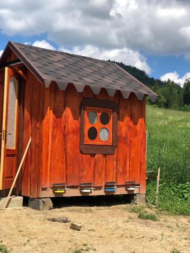 a wooden out house with a window in a field at Шервуд in Myta