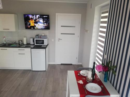 a small kitchen with a microwave and a table at MARKAS in Rewa