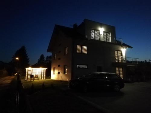 a house with a car parked in front of it at night at MARKAS in Rewa