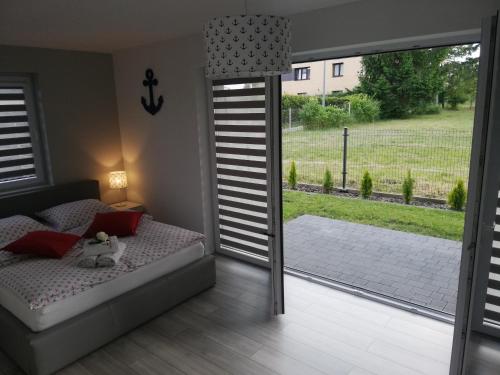 a bedroom with a bed and a sliding glass door at MARKAS in Rewa