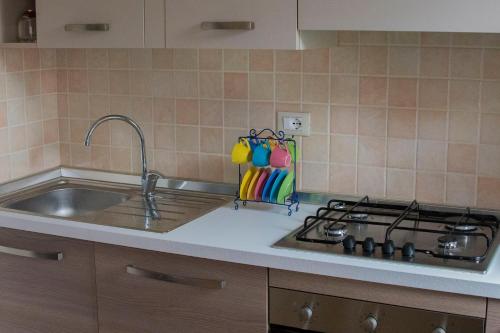 a kitchen counter with a sink and a stove at Lucca in Corte with free parking in Lucca
