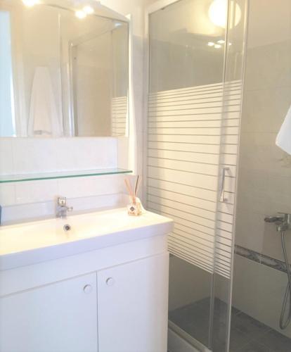 a bathroom with a sink and a shower at White Rooms Paros in Naousa