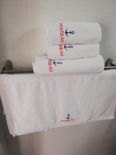 a stack of towels on a shelf in a bathroom at MARKAS in Rewa