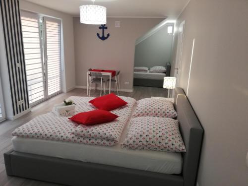 una camera da letto con un letto con cuscini rossi di MARKAS a Rewa