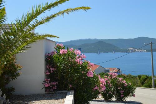 a view of the water from a house with flowers at Villa Mare in Klek