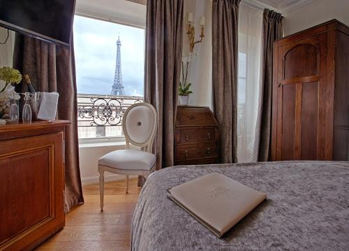 a bedroom with a bed and a view of the eiffel tower at Eiffel Trocadéro in Paris