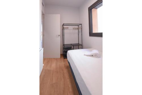 a bedroom with a white bed and a mirror at APG Girona Carme 19 in Girona