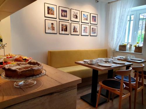 a dining room with a table with a cake on it at Casa Isabella B&B in Koper