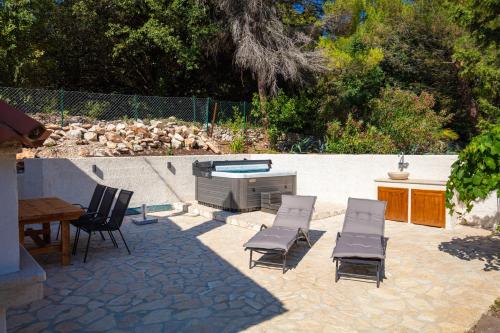 a patio with chairs and a table and a pool at Al Pino Blue Property in Premantura