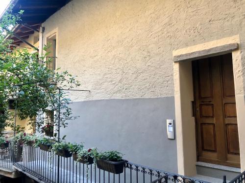a door of a house with potted plants on it at Domus Apartments in Aosta