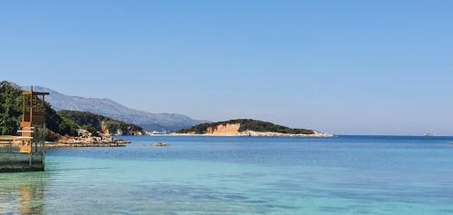 a large body of water with an island in the distance at Prestige Home KSAMIL in Ksamil
