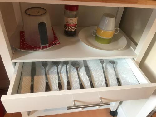 a drawer of a refrigerator with utensils at Studio-2 Staines,Heathrow, London-own entrance in Staines
