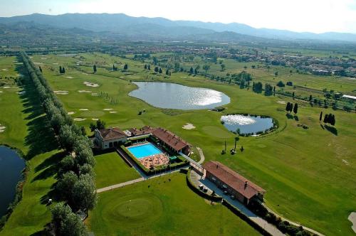 an aerial view of a golf course with a lake at Hotel Giardino in Prato