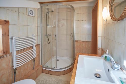 a bathroom with a shower and a sink at Apartament ze słoneczną werandą -250 m do plaży in Sopot
