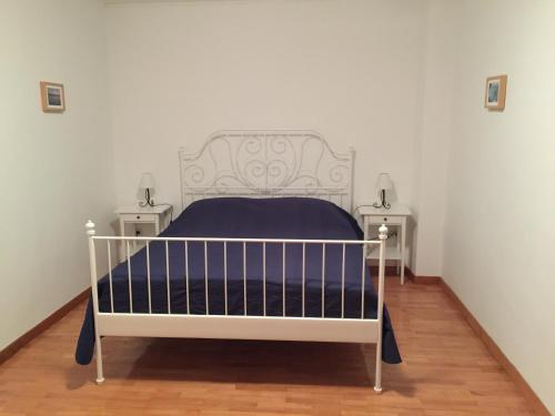 a white bed in a room with two night stands at Holiday Home Olea in Punat
