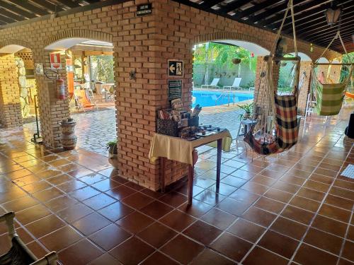 a room with a tile floor and a swimming pool at Pousada Na Praia Ubatuba in Ubatuba